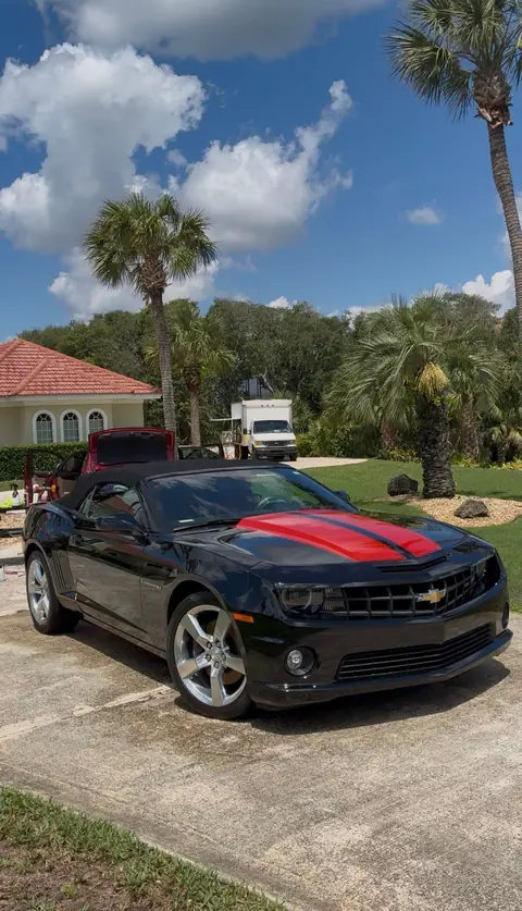 The same Camaro convertible after an exterior detail, with glossy black paint and bright, clean wheels