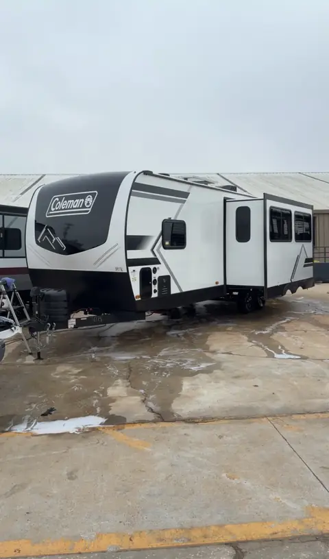 Coleman travel trailer being washed during an RV detail