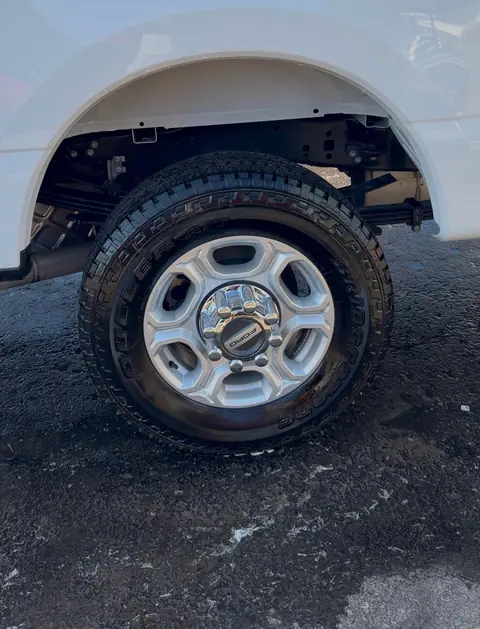 The same Ford Super Duty rear wheel after detailing, with a clean wheel well and dressed tire