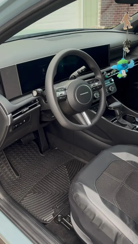 The same Hyundai sedan driver's area after an interior detail, with a clean rubber floor mat