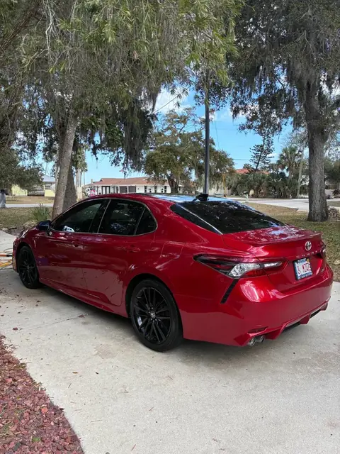 Glossy red Toyota Camry after an exterior detail